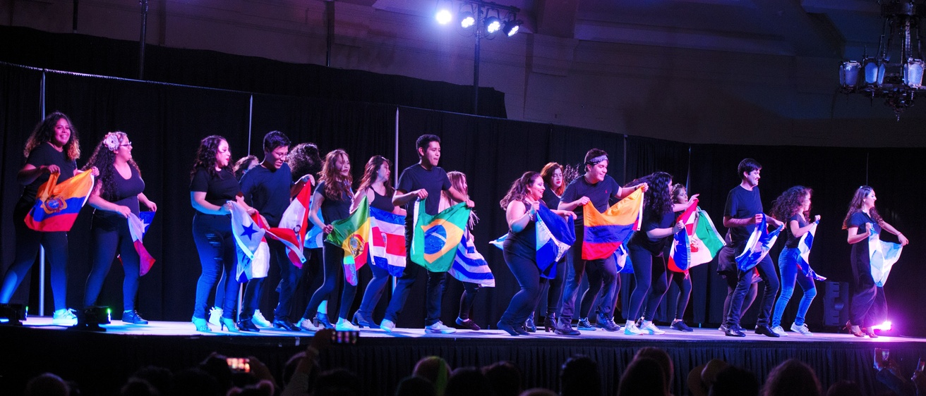 Walk It Out models on stage with flags from Latin America